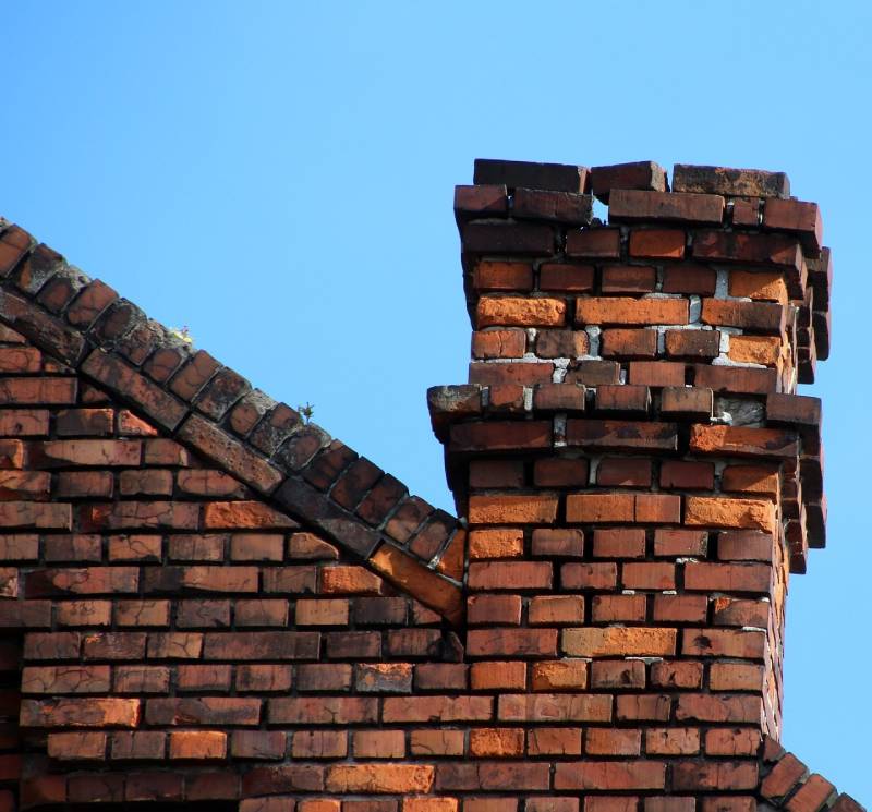 Damaged chimney on an El Monte home showing cracks and missing mortar